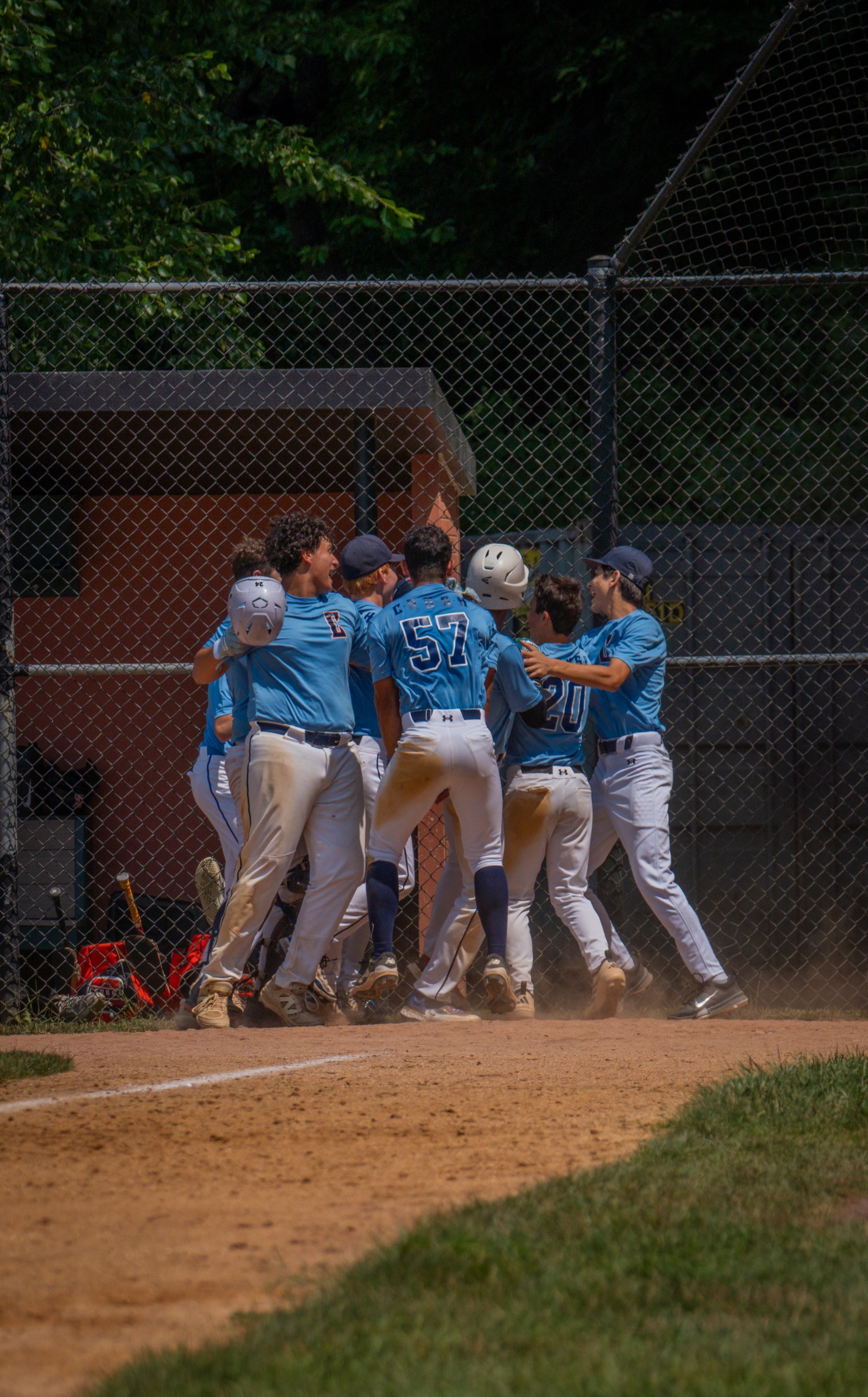 Baseball team celebrating together near home plate