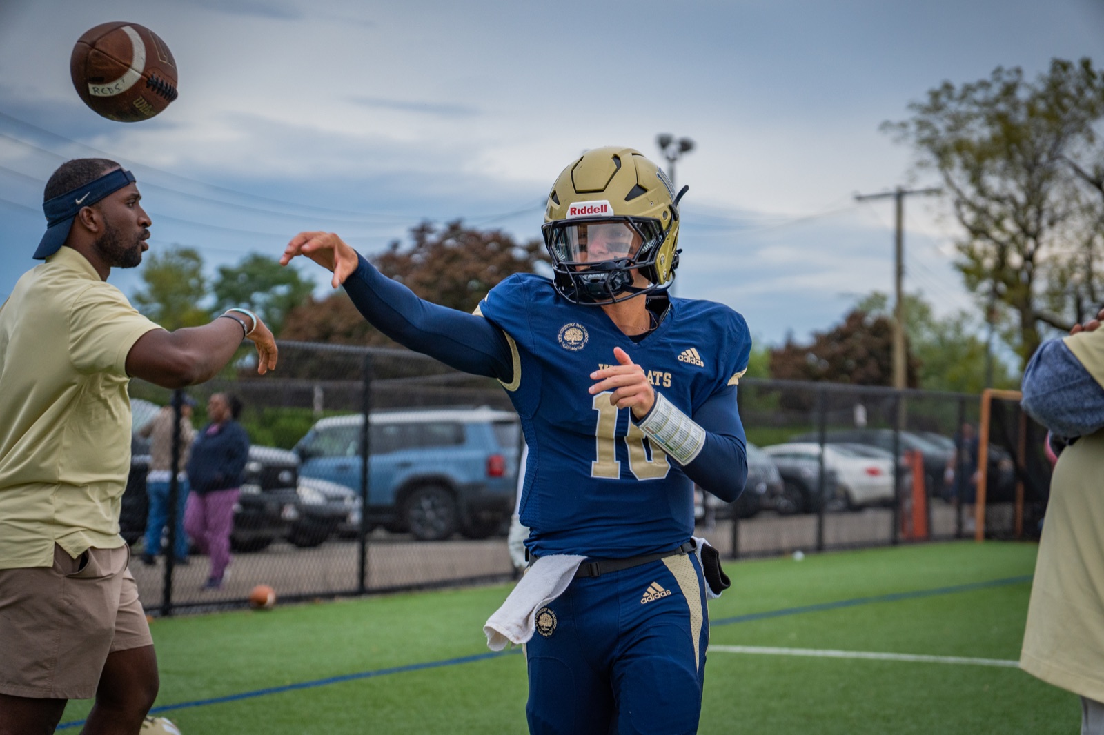 Quarterback releasing a pass during warmups