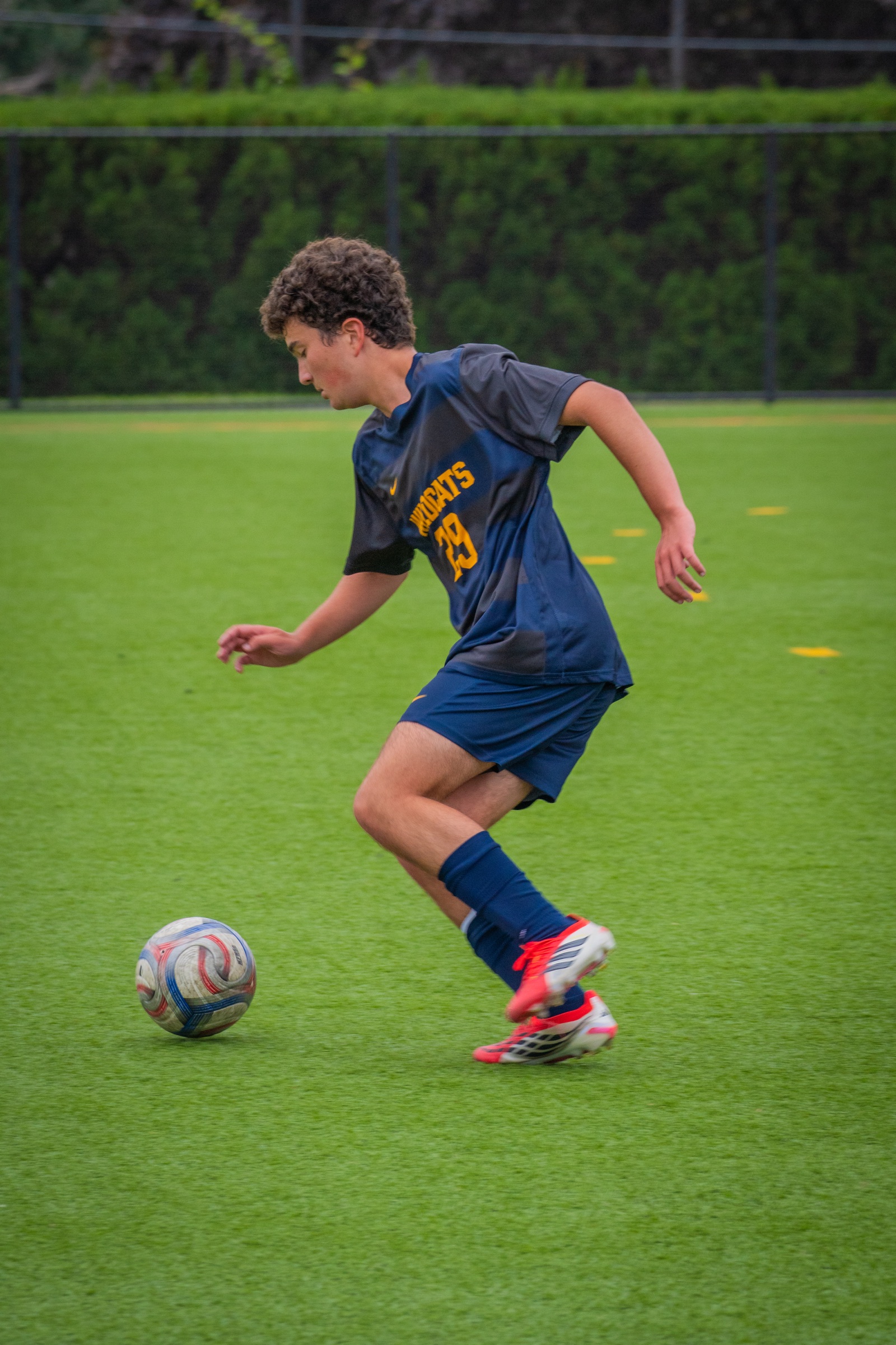 Soccer player carrying the ball through open space